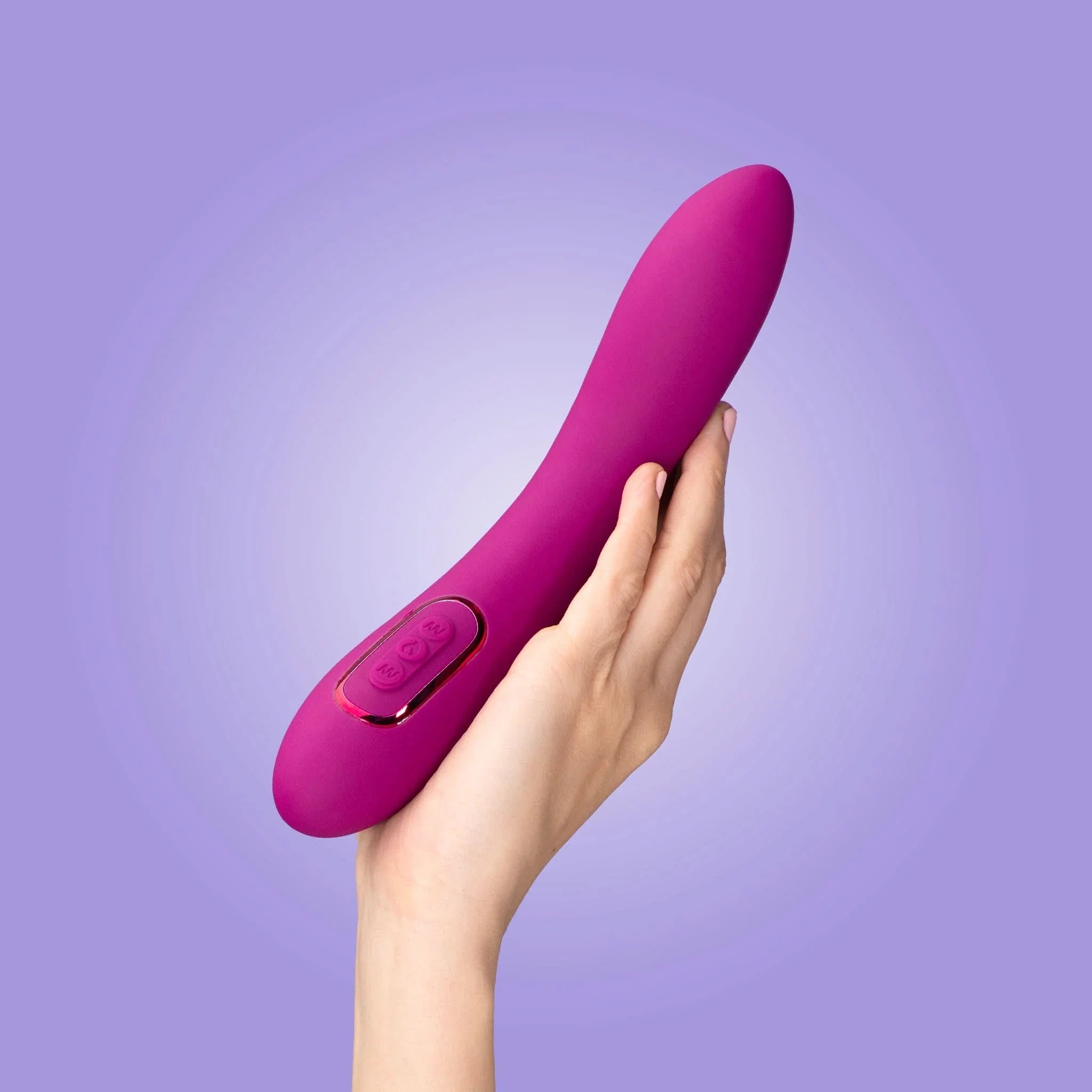 A hand holds the pink JIMMYJANE® Solis™ Form 6® silicone vibrator with an ergonomic design against a purple background.