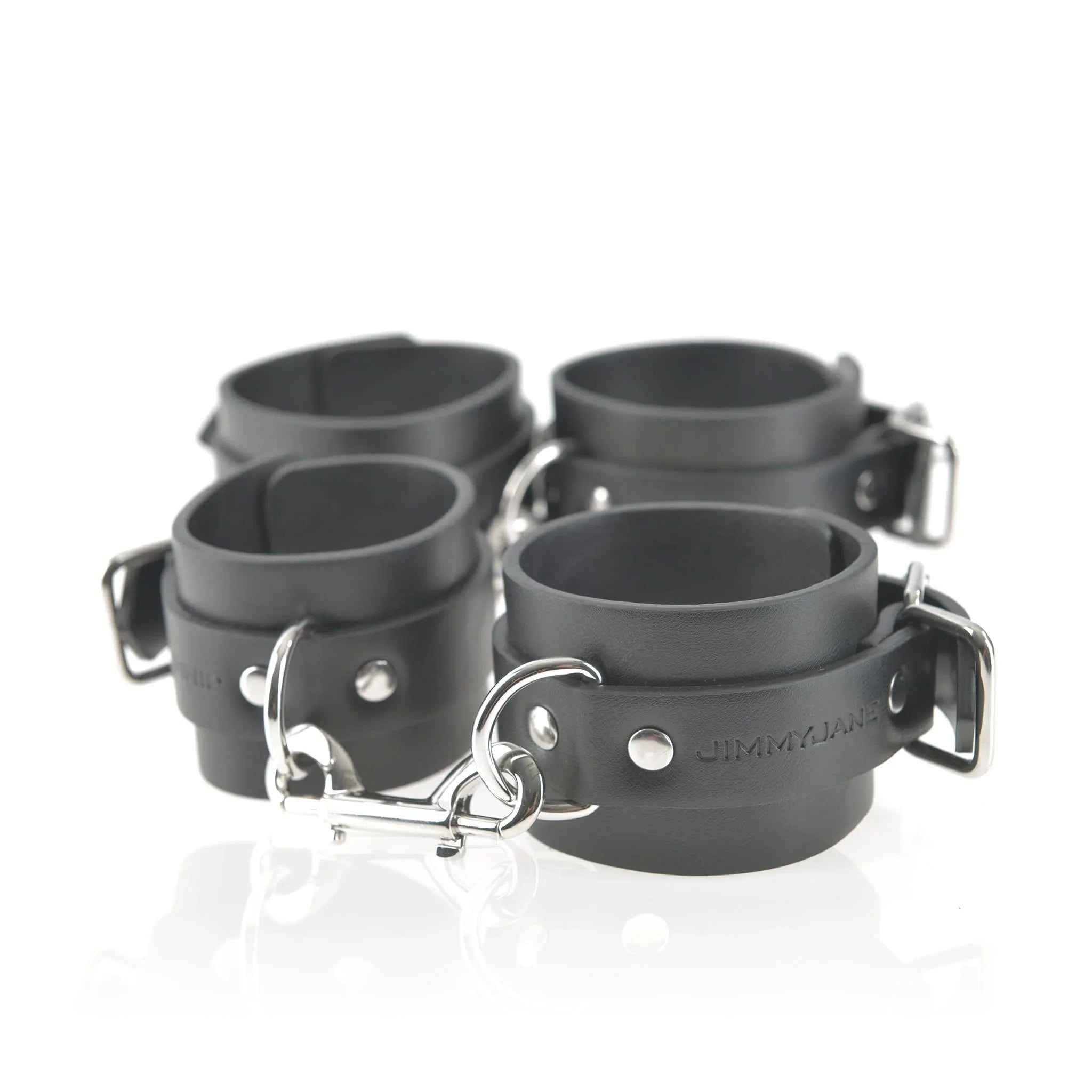 The JIMMYJANE® 7-Piece Bondage Set features black vegan leather wrist or ankle cuffs with metal buckles and connecting rings—perfect for any couple looking to enhance their experience.