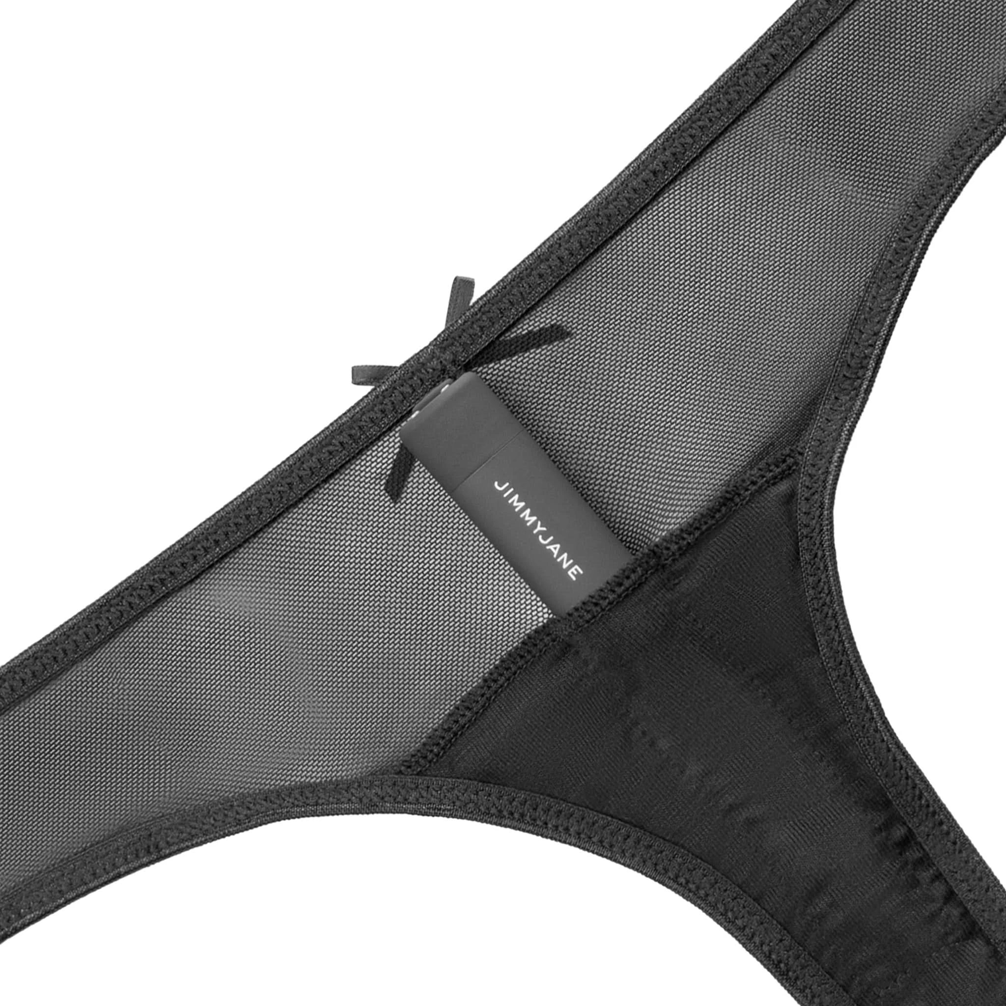 Close-up of a black mesh thong with a bow and JIMMYJANE® label, echoing the Calista™ Vibrating Panties style—pairs perfectly with the Starla Black Bullet Vibrator in this JIMMYJANE® bundle.