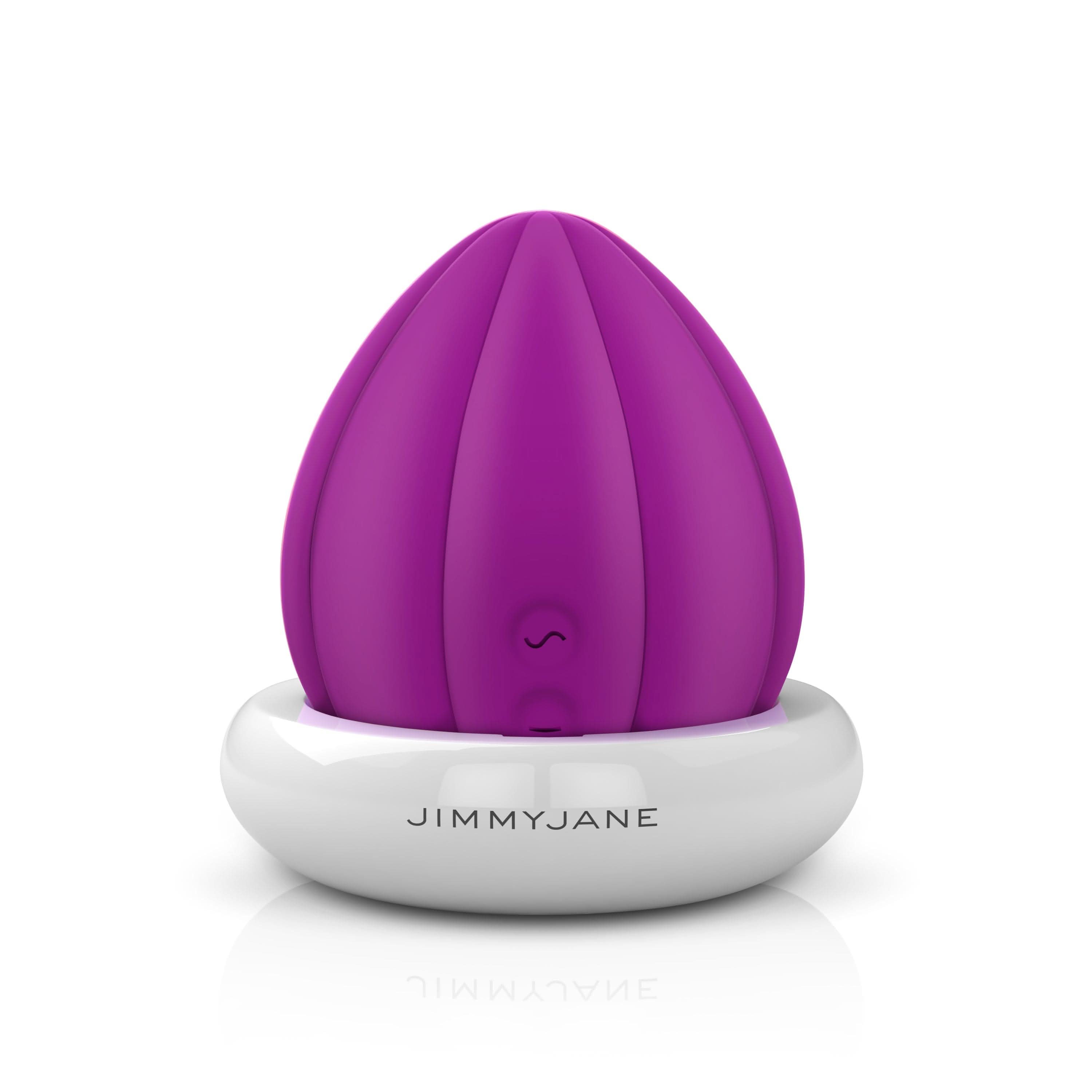 The JIMMYJANE® Love Pods™ Om is a purple, tulip-shaped vibrator on a white charging base, designed for clitoral stimulation and shown against a white background.