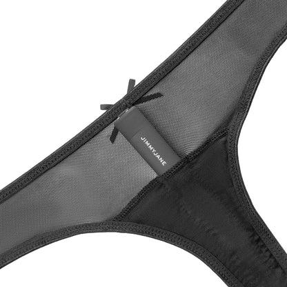 Close-up of a black mesh thong with a bow and JIMMYJANE® label, echoing the Calista™ Vibrating Panties style—pairs perfectly with the Starla Black Bullet Vibrator in this JIMMYJANE® bundle.